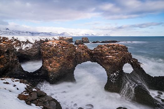Gatklettur arch in the ocean in Arnarstapi village, Iceland