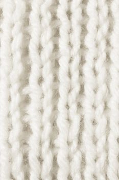 White Wool Knitting Texture. Vertical Across Weaving Crochet Detailed Rows. Sweater Textile Background. Macro Closeup.