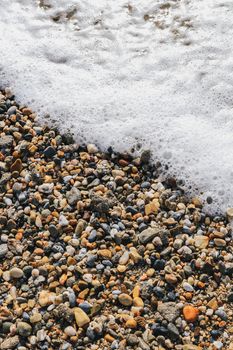 Sea water foam on the beach stones. Nautical marine summer background. Alanya. Turkey.