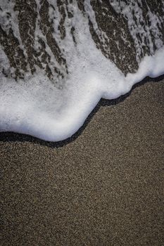 Sea beach texture with wave foam. Marine background.