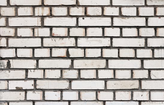 White bricks wall texture with cement stains. 