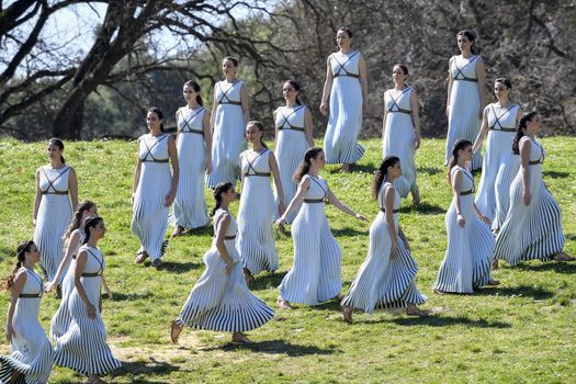 Olympia, Greece -  March 12, 2020: Olympic Flame handover ceremony for the Tokyo 2020 Summer Olympic Games at the Ancient Olympia site, birthplace of the ancient Olympics in southern Greece.