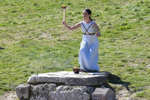 Olympia, Greece -  March 12, 2020: Olympic Flame handover ceremony for the Tokyo 2020 Summer Olympic Games at the Ancient Olympia site, birthplace of the ancient Olympics in southern Greece.