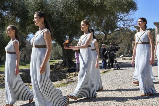 Olympia, Greece -  March 12, 2020: Olympic Flame handover ceremony for the Tokyo 2020 Summer Olympic Games at the Ancient Olympia site, birthplace of the ancient Olympics in southern Greece.