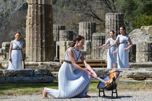 Olympia, Greece -  March 12, 2020: Olympic Flame handover ceremony for the Tokyo 2020 Summer Olympic Games at the Ancient Olympia site, birthplace of the ancient Olympics in southern Greece.