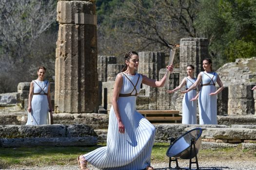 Olympia, Greece -  March 12, 2020: Olympic Flame handover ceremony for the Tokyo 2020 Summer Olympic Games at the Ancient Olympia site, birthplace of the ancient Olympics in southern Greece.