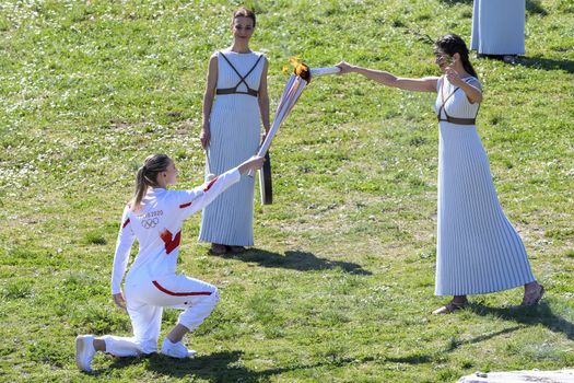 Olympia, Greece -  March 12, 2020: Olympic Flame handover ceremony for the Tokyo 2020 Summer Olympic Games at the Ancient Olympia site, birthplace of the ancient Olympics in southern Greece.