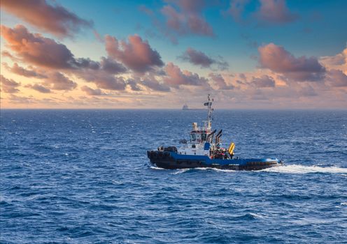 A blue tugboat working the waters of Curacao