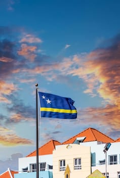 Colorful Buildings with Curacao Flag under blue skies