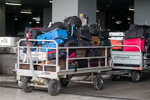 Thessaloniki, Greece - June 18, 2015: luggage cart on the runway of the airport Macedonia a rainy day 