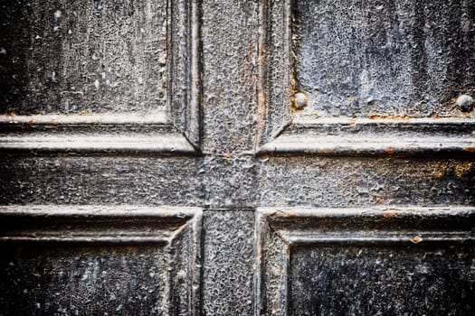 Closeup of metal vintage door , selective focus, image cross processed for vintage look