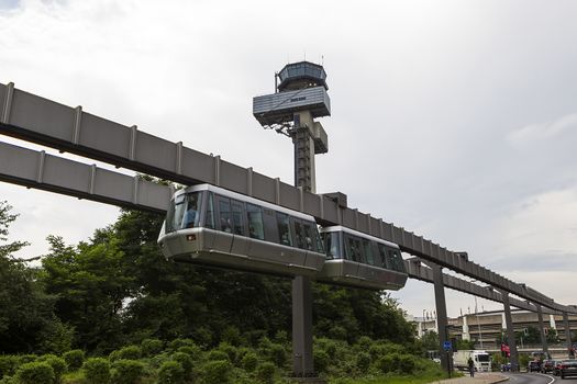 DUSSELDORF, GERMANY- JULY 5, 2012: Public transportation system Sky-Train hanging from elevated guideway beam on columns in Dusseldorf, Germany. The SkyTrain, takes passengers to the airport terminal.