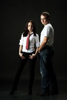 handsome young couple posing standing in studio