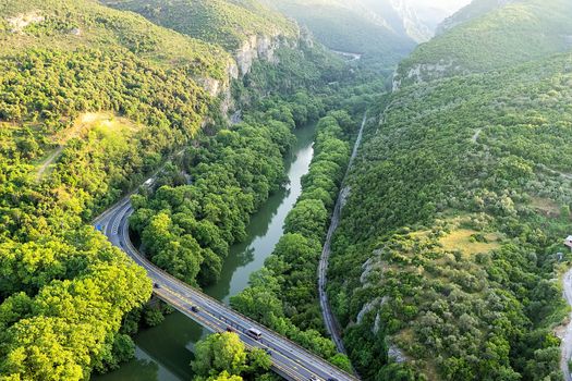 Aerial view of the bridge and the road over the river Pinios in the green valley of Tempe in Greece