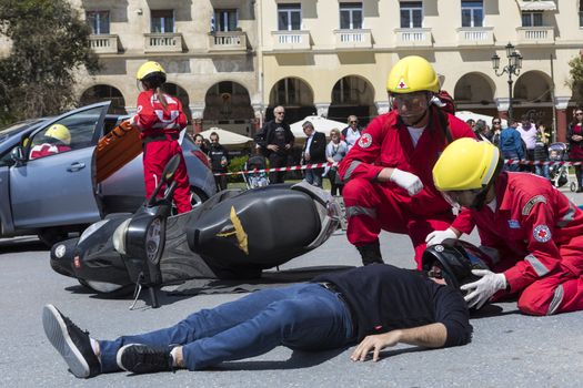 Thessaloniki , Greece - April 9, 2017: First aid, victim liberation in an car accident and helmet removal demonstration by the Hellenic Red Cross rescue team