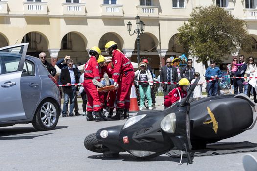 Thessaloniki , Greece - April 9, 2017: First aid, victim liberation in an car accident and helmet removal demonstration by the Hellenic Red Cross rescue team