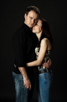 handsome young couple posing standing in studio