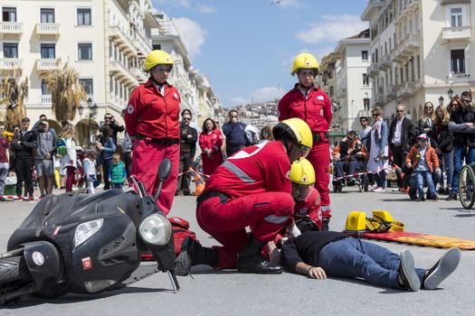 Thessaloniki , Greece - April 9, 2017: First aid, victim liberation in an car accident and helmet removal demonstration by the Hellenic Red Cross rescue team