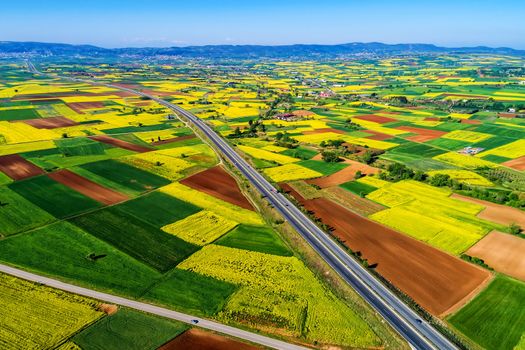 Aerial view of road passing through a rural landscape with blooming in northern Greece