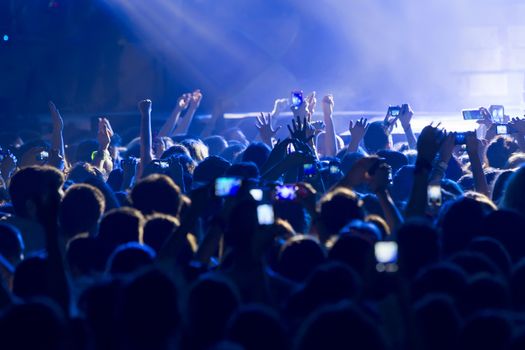 THESSALONIKI, GREECE, MAY 8 2014:People taking photographs with touch smart phone during a music concert live on stage for the Ace of Heart tour at Sports arena in Thessaloniki.