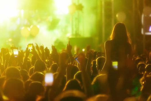 Hand with a smartphone records live music festival, Taking photo of concert stage, live concert, music festival, happy youth, luxury party, landscape exterior