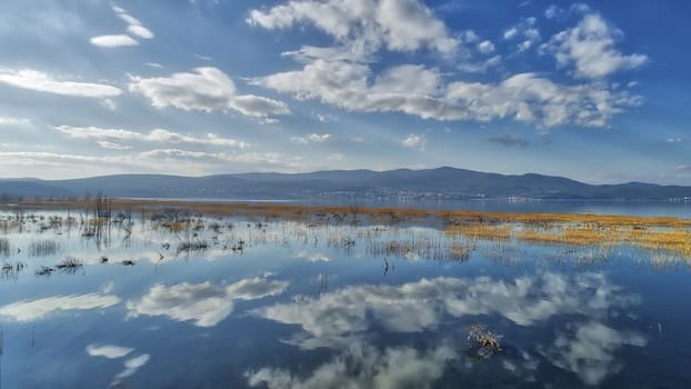 reflection of clouds at the wetland of Lake Doriani on a winter day in northern Greece. atmospheric effect