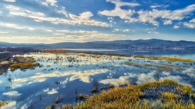 reflection of clouds at the wetland of Lake Doriani on a winter day in northern Greece. atmospheric effect