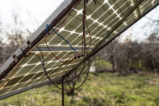 Old small solar panel photovoltaic electric system for home in the village. Alternative energy concept.