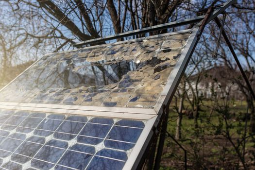 Destroyed old small solar panel photovoltaic electric system for home in the village. Alternative energy concept.