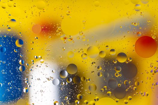 The abstract composition with oil drops in water. Yellow main color.