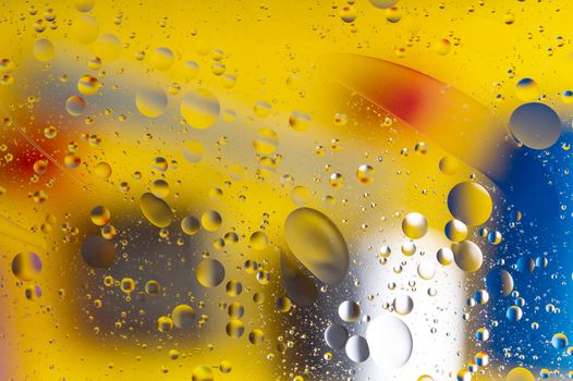 The abstract composition with oil drops in water. Yellow main color.