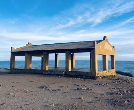 Beautiful view of a incomplete ruined building near the seashore of the Manapad coastline. This shot was taken during the golden hours of the evening sunset time at an autumn season.