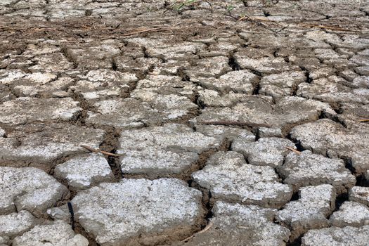 Dry lake bed with natural texture of cracked clay in perspective floor. Death Valley field . background. Selective focus on black soil dark land. Idea concept symbol disaster ecology in nature