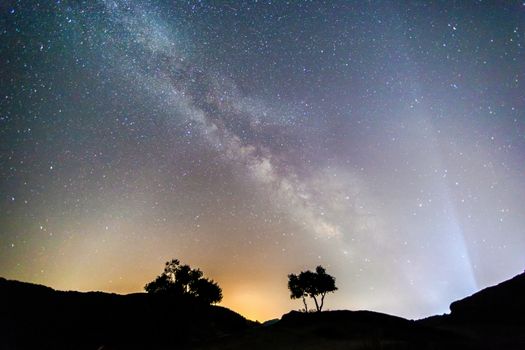 Milky Way over the Meteora, Greece. long exposure; Image contain noise, blur due to slow shutter speed.