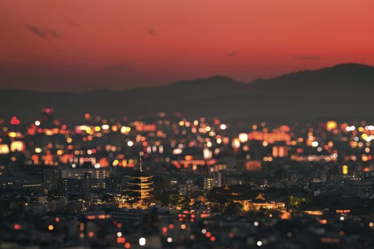 The toji temple  and its pagoda in the sunset on the city of Kyoto illuminated with thousand fires.