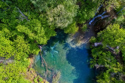 beautiful waterfall and small lake with green waters in the green forest in Skra at north Greece