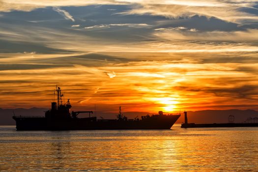 Bulk-carrier ship at sunset in the sea