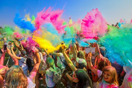 Thessaloniki, Greece - September 2, 2018: Crowds of unidentified people throw colour powder during the "Day of Colours" annual event.