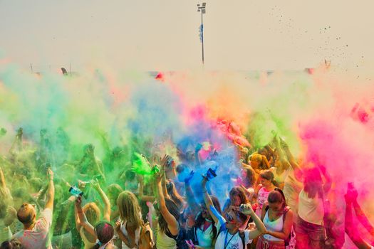 Thessaloniki, Greece - September 2, 2018: Crowds of unidentified people throw colour powder during the "Day of Colours" annual event.