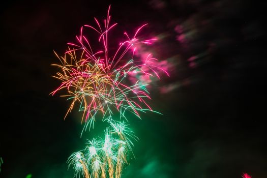 Colorful fireworks of various colors over night sky