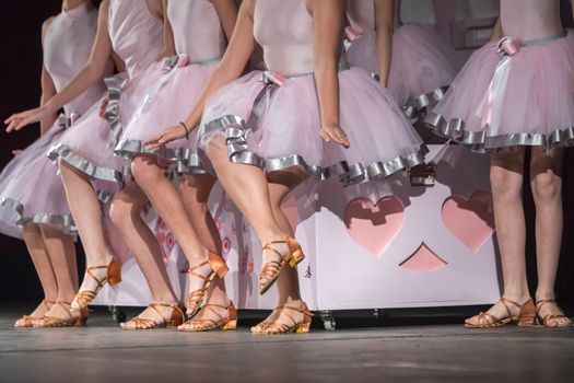 Legs of young dancers on the dance floor 