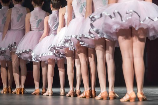 Legs of young dancers on the dance floor 