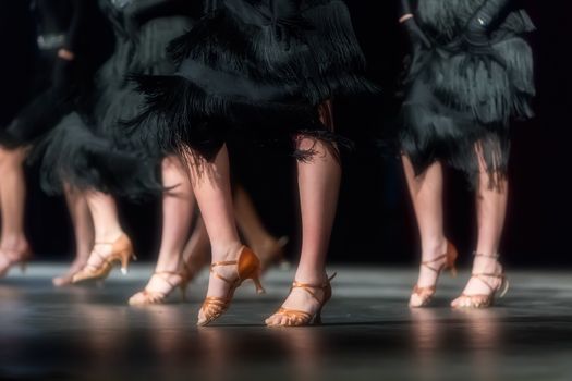 Legs of young dancers on the dance floor 