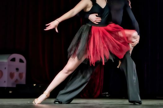 Legs of young dancers on the dance floor 