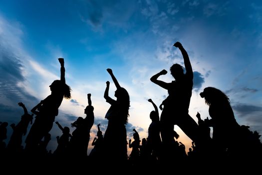 silhouettes of young people dancing