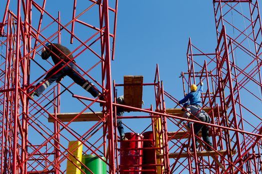 Construction workers building a new structure in city