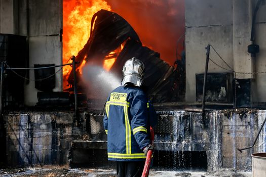 Aspopirgos, Greece - March 28, 2016: Firefighters struggle to extinguish the fire that broke out at a paint factory