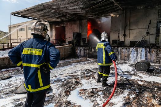 Aspopirgos, Greece - March 28, 2016: Firefighters struggle to extinguish the fire that broke out at a paint factory