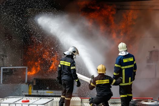 Aspopirgos, Greece - March 28, 2016: Firefighters struggle to extinguish the fire that broke out at a paint factory