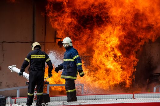 Aspopirgos, Greece - March 28, 2016: Firefighters struggle to extinguish the fire that broke out at a paint factory
